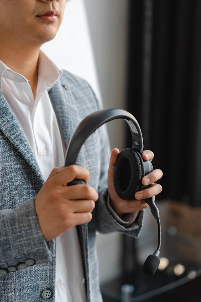 Business professional holding a headset, ideal for call center or customer service concepts.